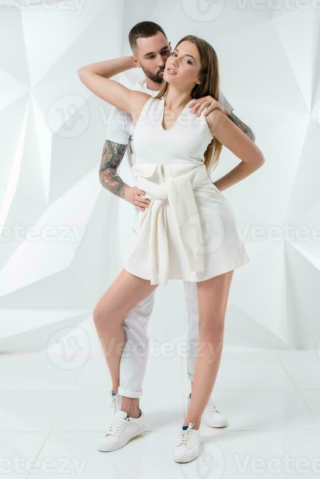 Young couple in casual clothing on white background photo