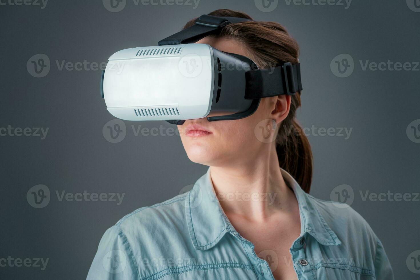 portrait of happy young beautiful girl getting experience using VR-headset glasses of virtual reality photo