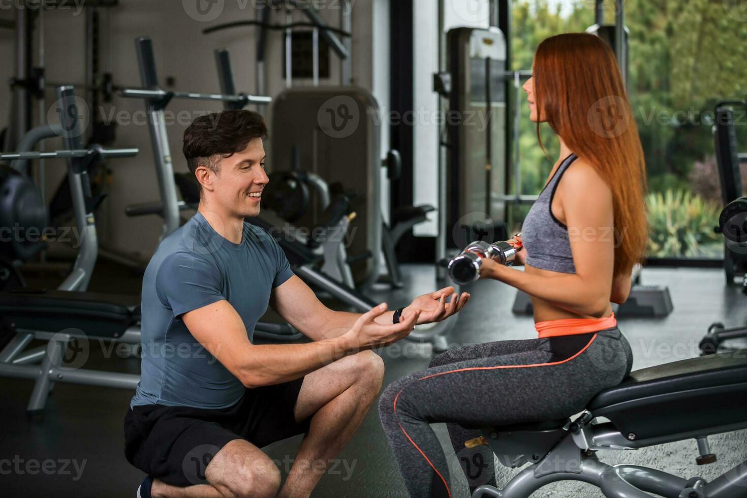 happy cutie athletic girl , execute exercise with dumb-bells photo