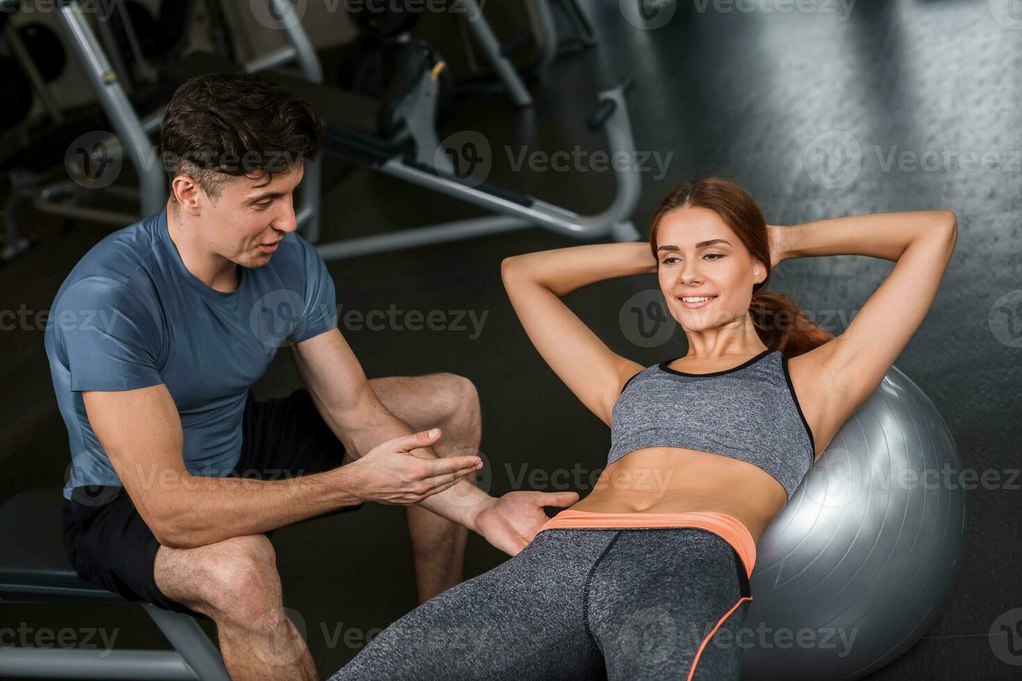 happy cutie athletic girl , execute exercise in sport-hall photo