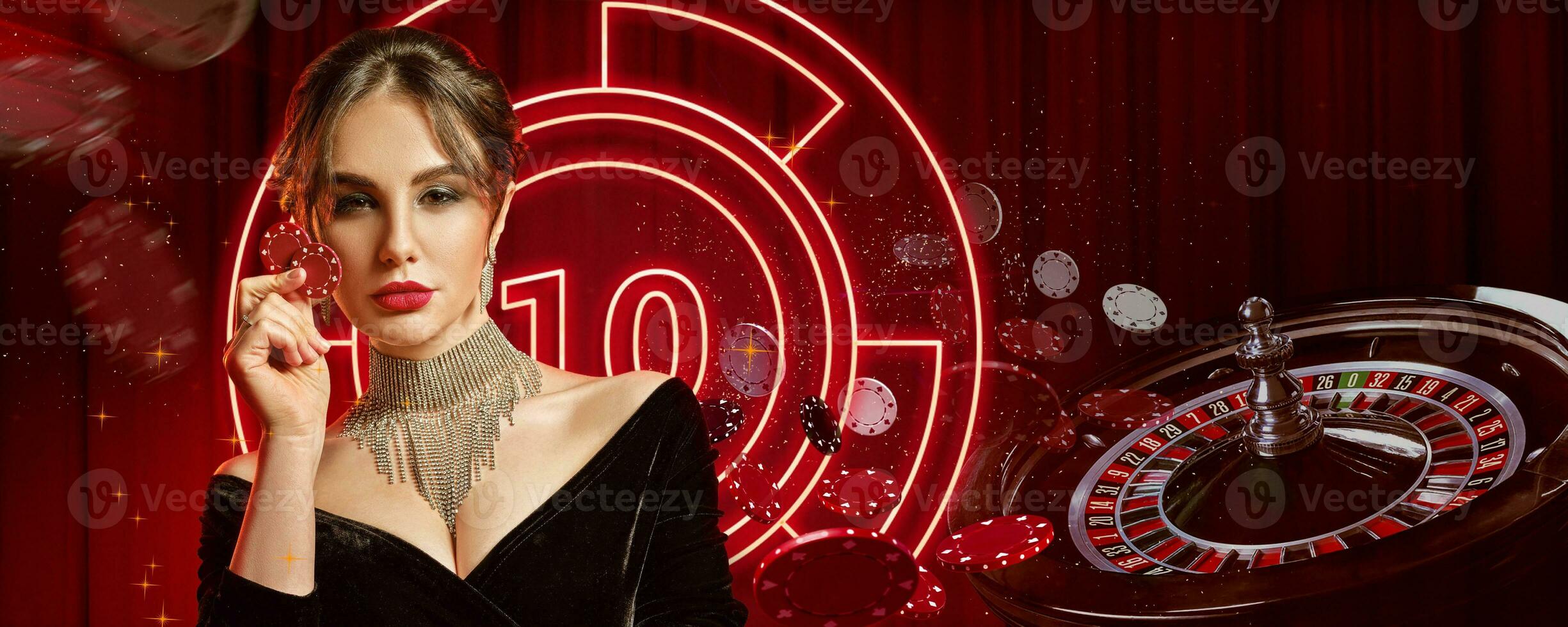 Girl in jewelry and black dress. Showing two red chips, posing on colorful background with neon lights, roulette and chips. Poker, casino. Close-up photo