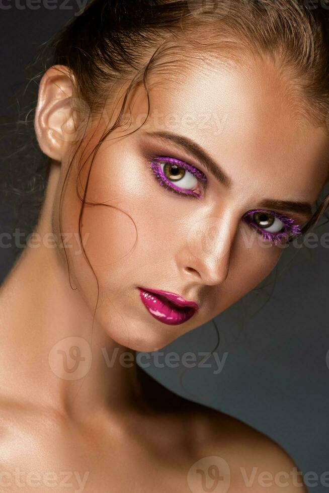 Beauty woman face closeup isolated on black background. photo