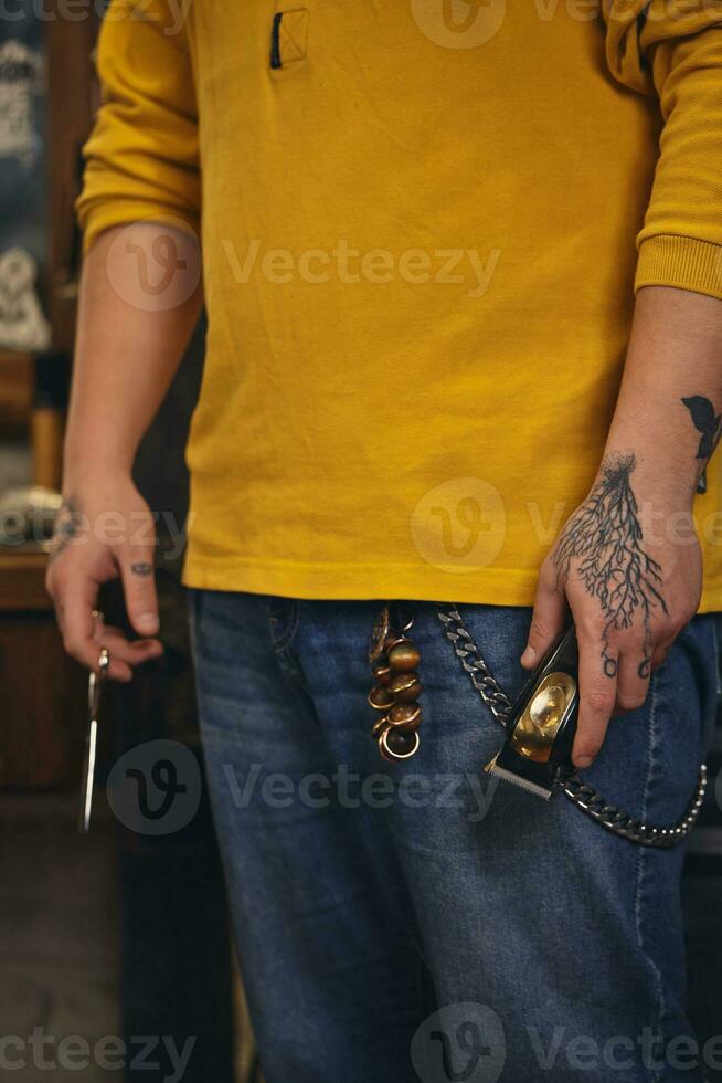 Stylish barber man with hairdressing tools in his hands prepare for work photo