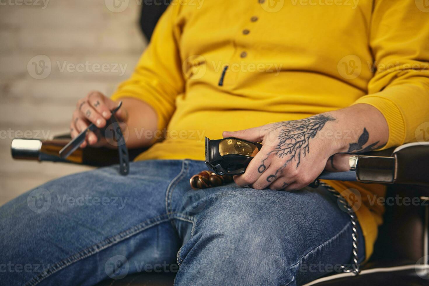 Stylish barber man with hairdressing tools in his hands prepare for work photo
