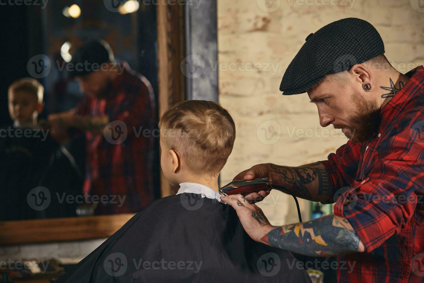 Caucasian boy getting haircut in barbershop indoor photo
