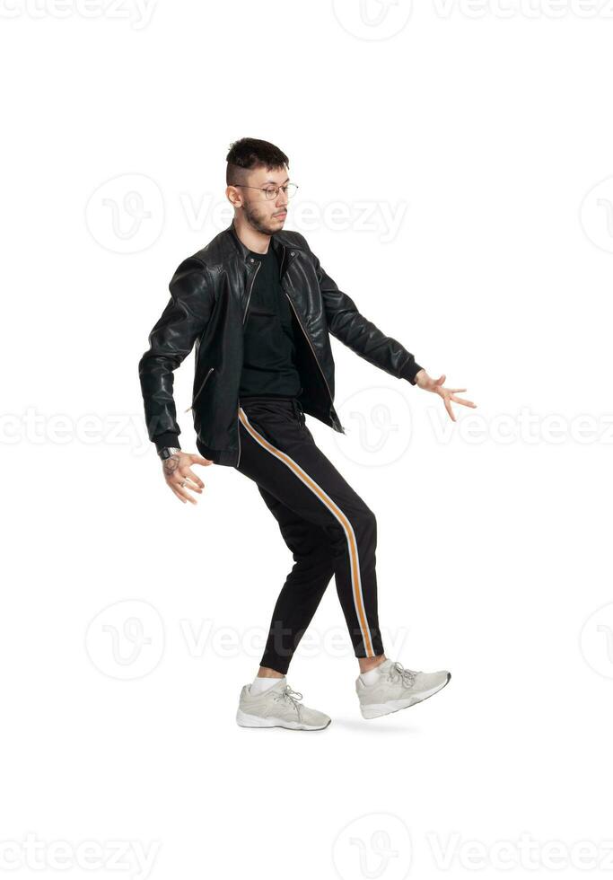 Full-length photo of a funny guy dancing in studio isolated on white background.