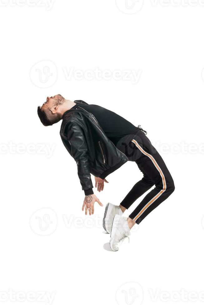 Full-length photo of a funny guy dancing in studio isolated on white background.