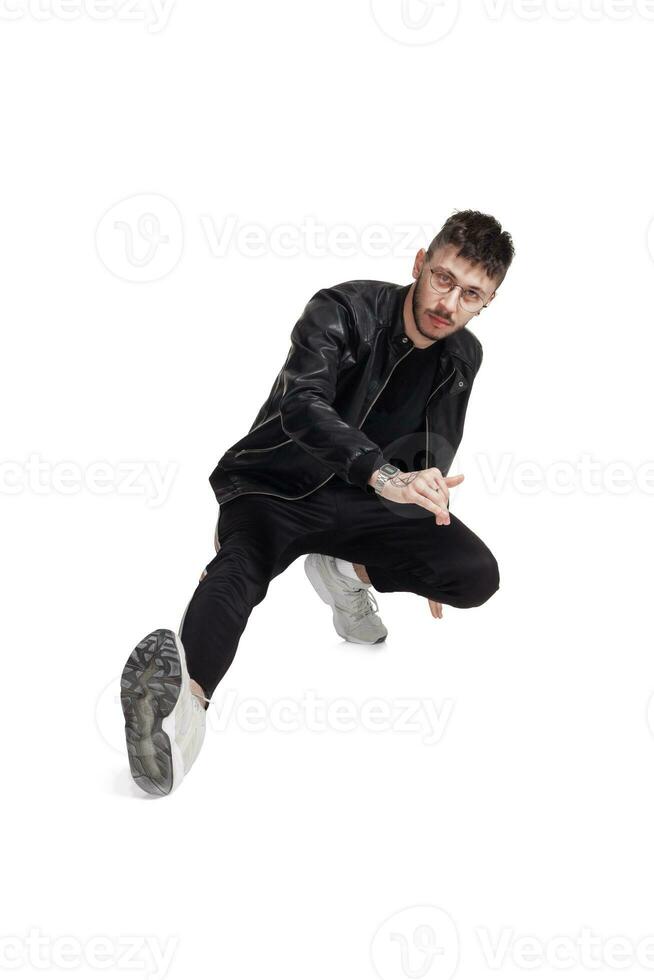Full-length photo of a funny guy dancing in studio isolated on white background.