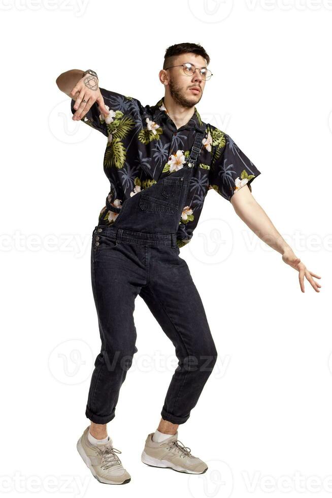 Full-length portrait of a funny guy dancing in studio isolated on white background. photo