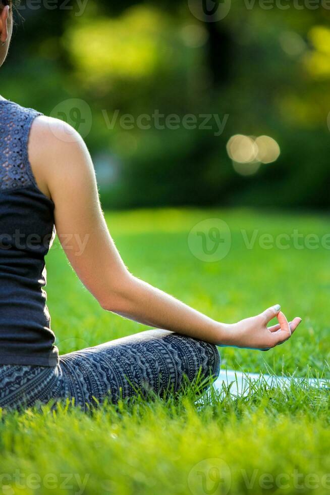 a woman in a white dress is doing yoga in front of a waterfall