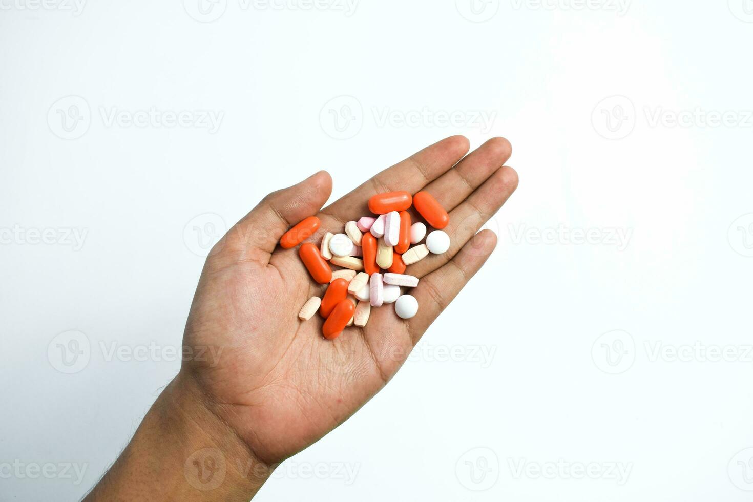 Colorful Medicine pills in man two hands on white background photo