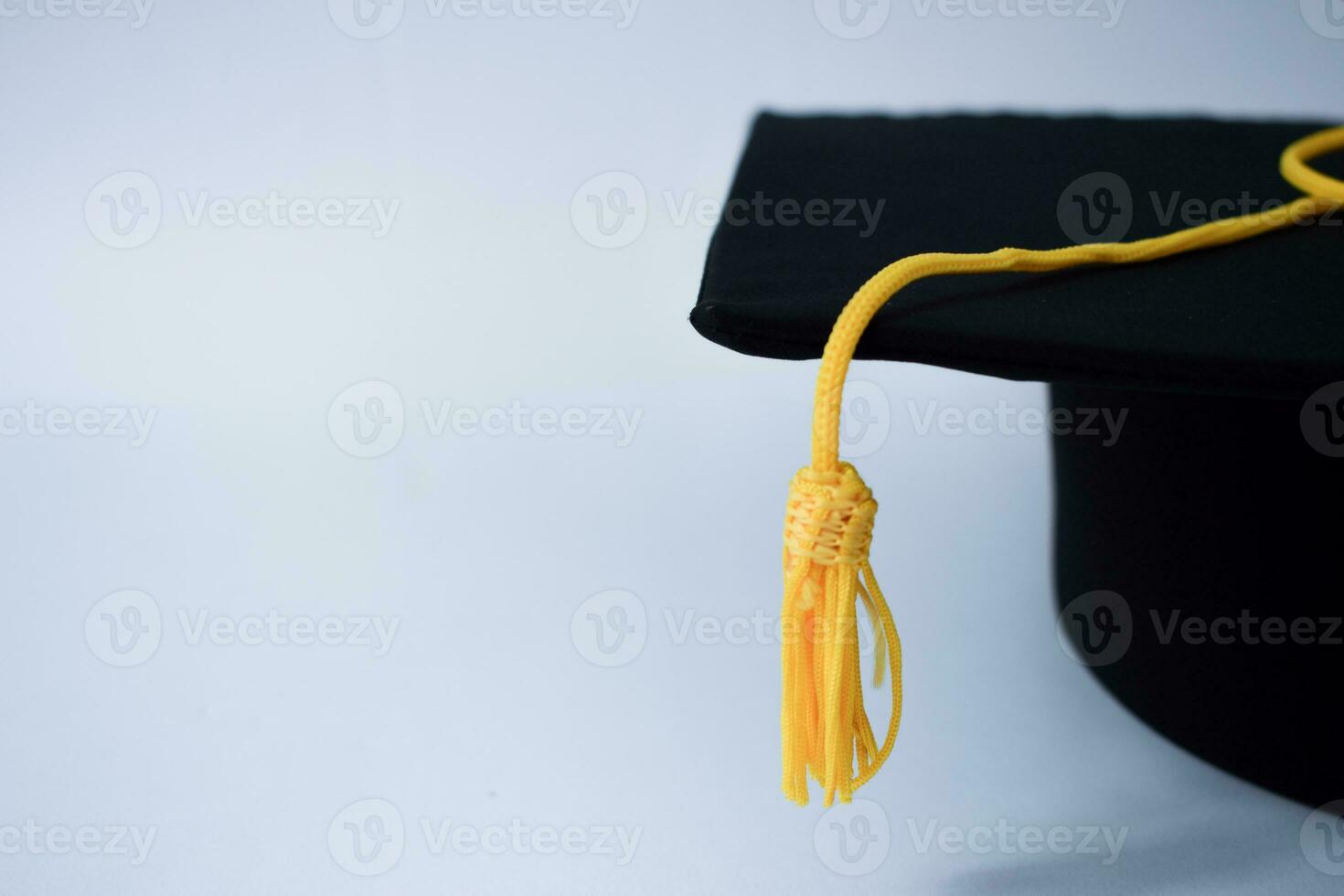 Close up Black Graduation Hat and Yellow Tassel isolated on white background photo