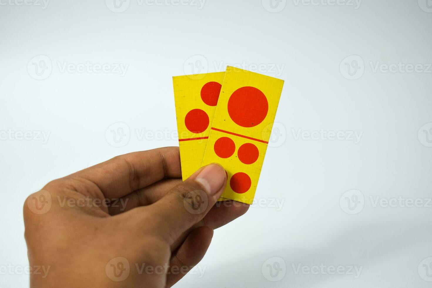 hand hold dominoes playing cards isolated white background, yellow red dominoes cards photo