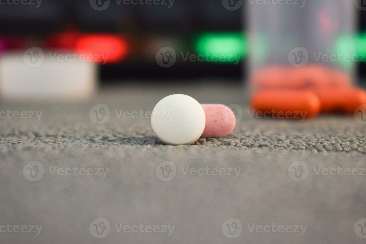 medical pill and bottle with mug or glas of water on table workspace photo