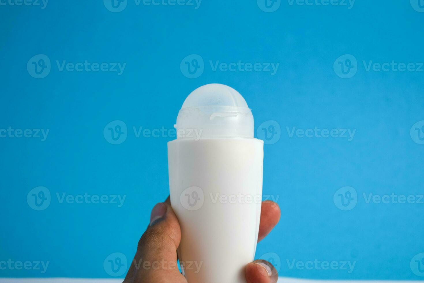 White bottle deodorant blank for mock up on blue background, product mock up, armpit health care, body care photo