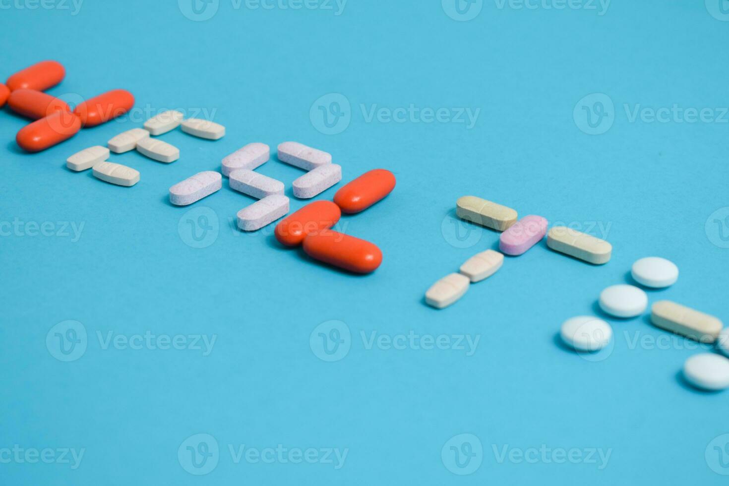 health word from Colorful Medicine Pills isolated on blue background, supplement, vitamin, colorful photo