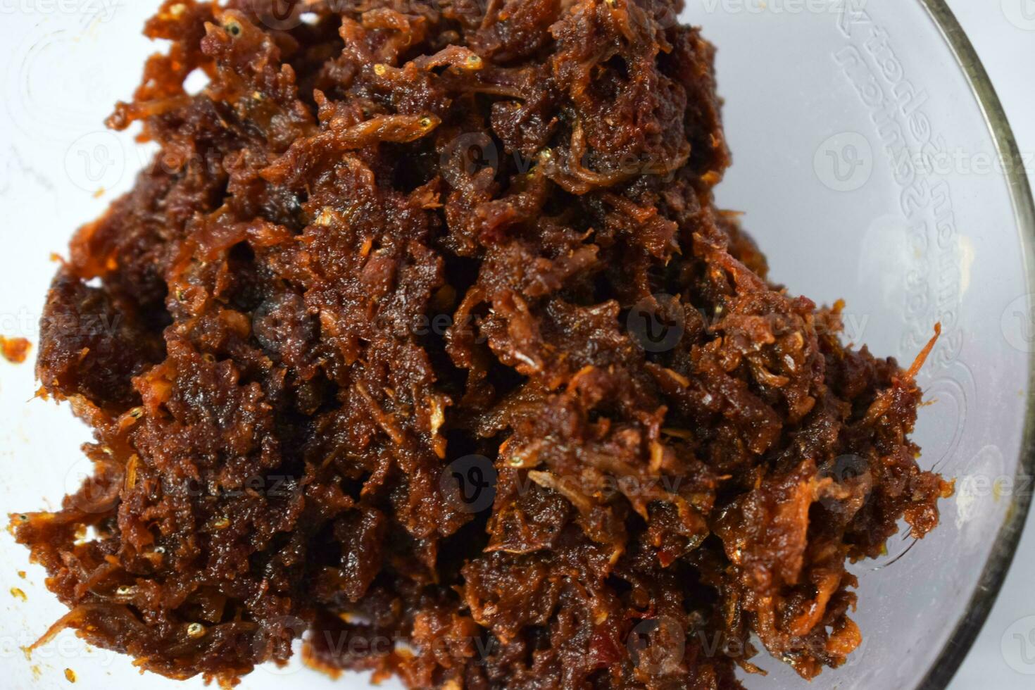 Close up Sambal ikan teri or anchovy chili fried is indoneisan side food, Indonesian chili sauce. Sambal ikan teri shoot on White Background. photo