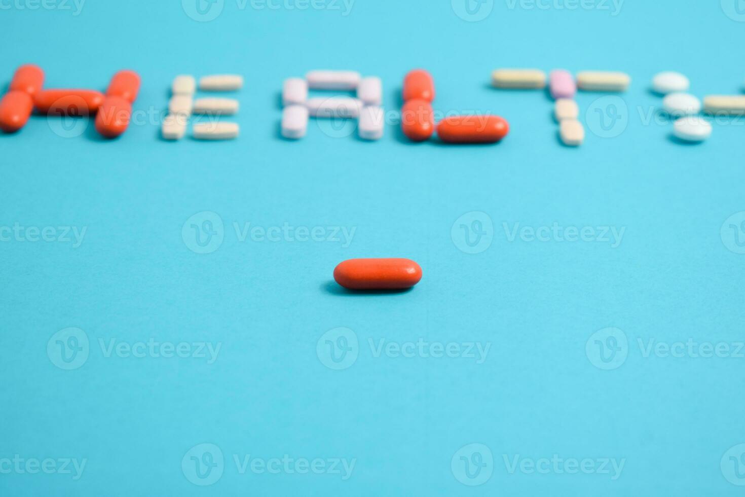 red medicine pill on health word blurred background blue, supplement, vitamin, colorful photo