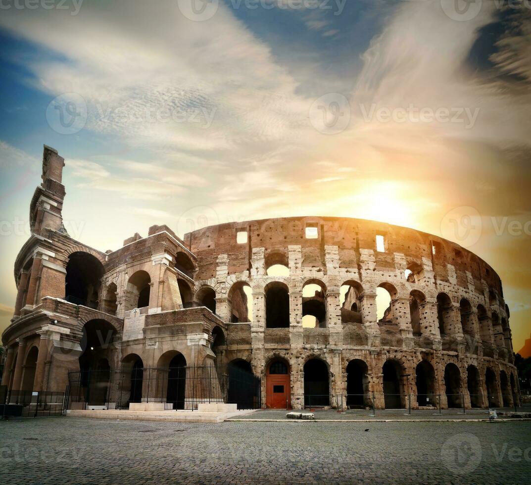 Bright sun and Colosseum photo