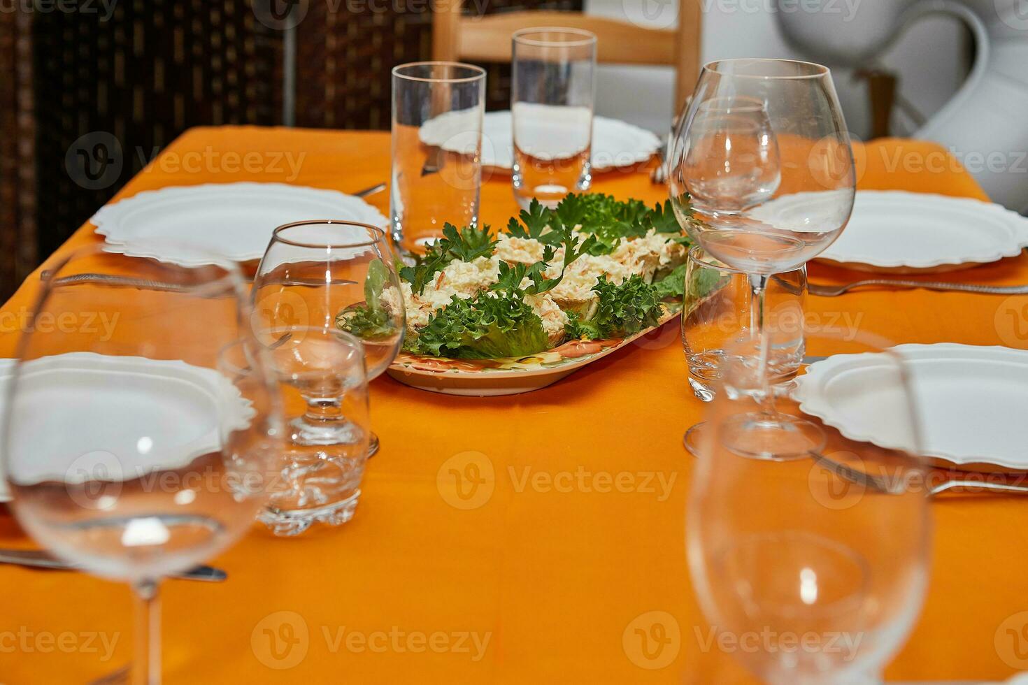 Elegant Table Setting with Glasses, Plates, and Delicacies for New Year's Celebration photo
