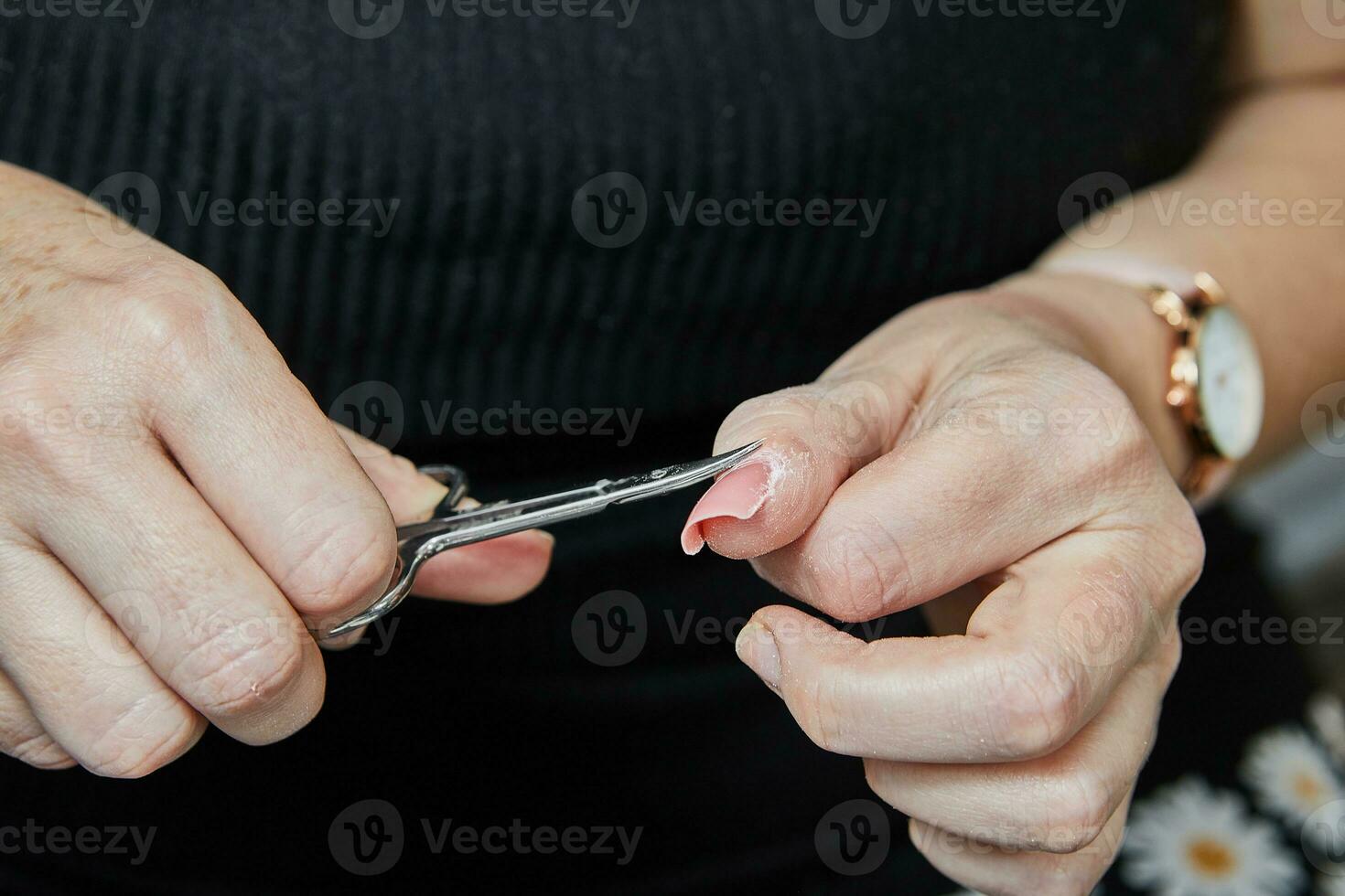 Professional Nail Technician Performing Gel Nail Extension and Manicure Using Machine photo
