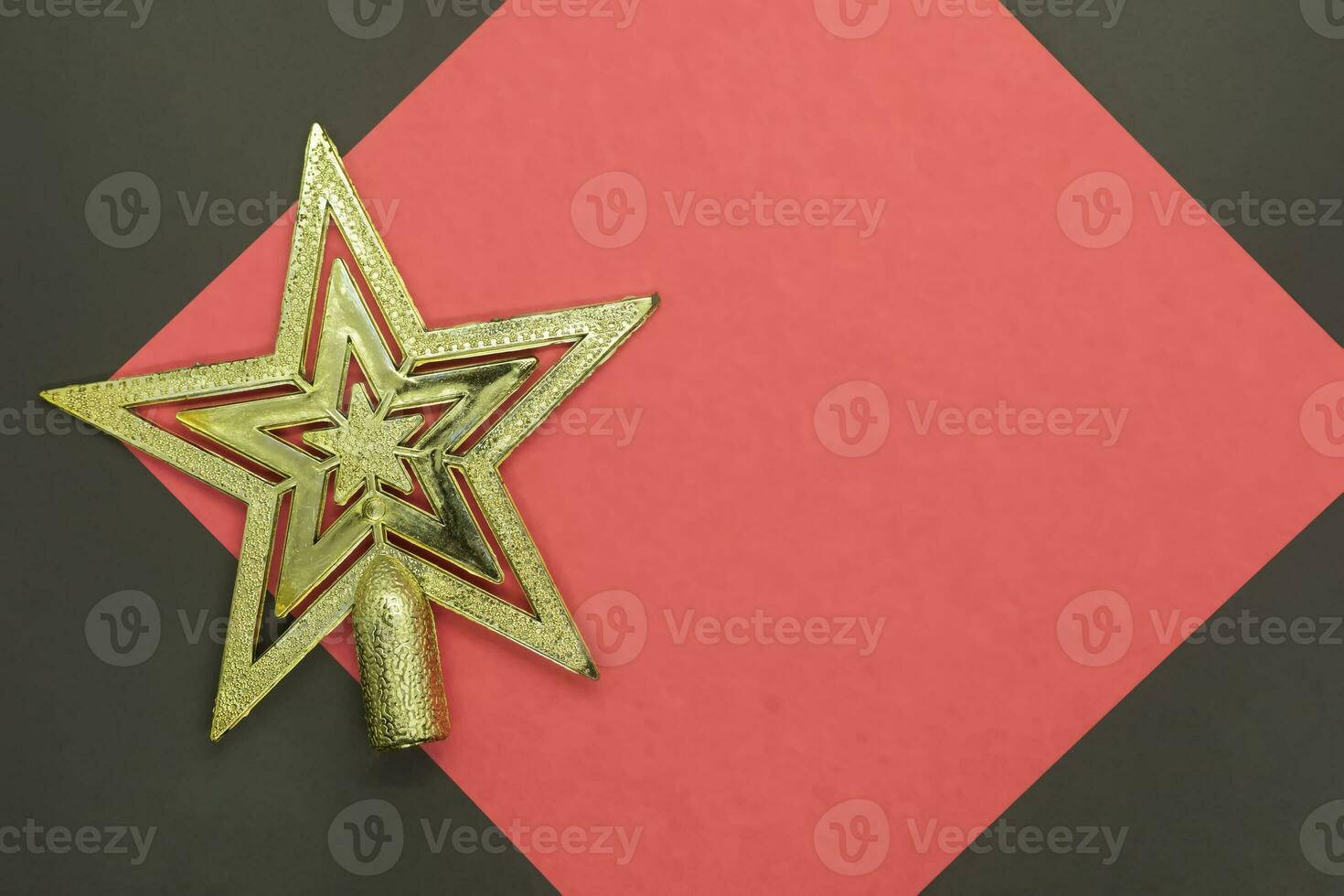 Christmas star on a red and black background with copy space for text photo
