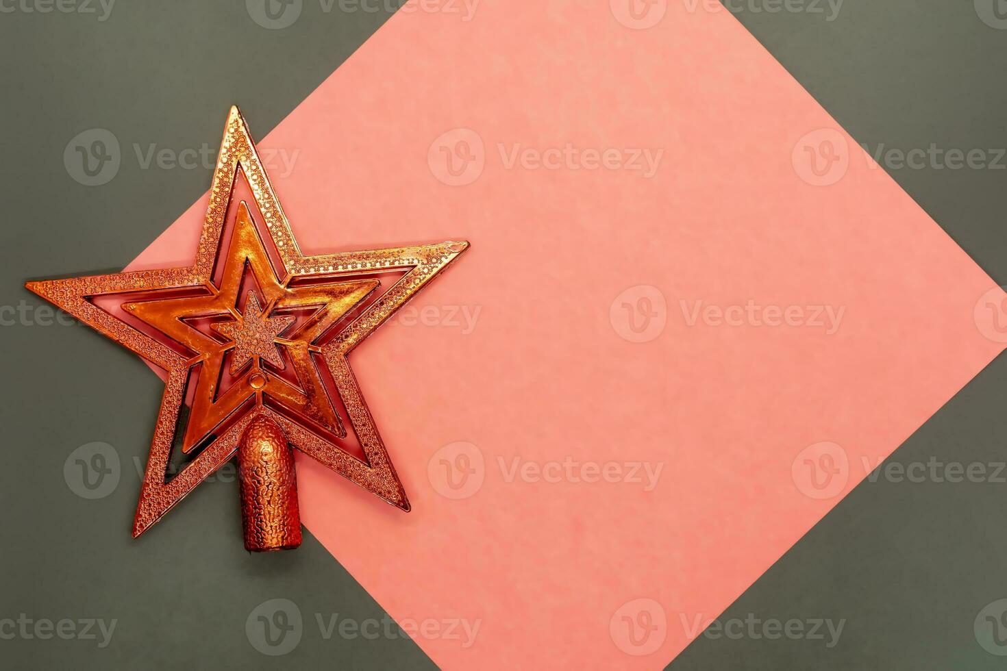 Christmas star decoration on a red and gray background with copy space. photo