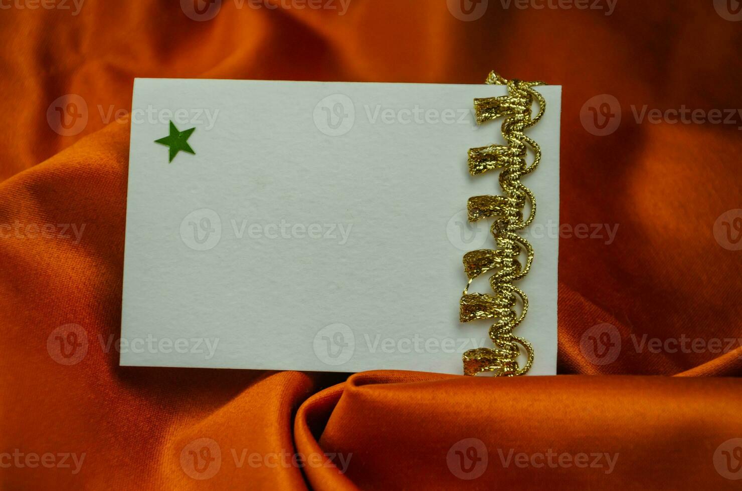 Textured brown background with writing card with gold decoration, shiny stars scattered around. High quality photo