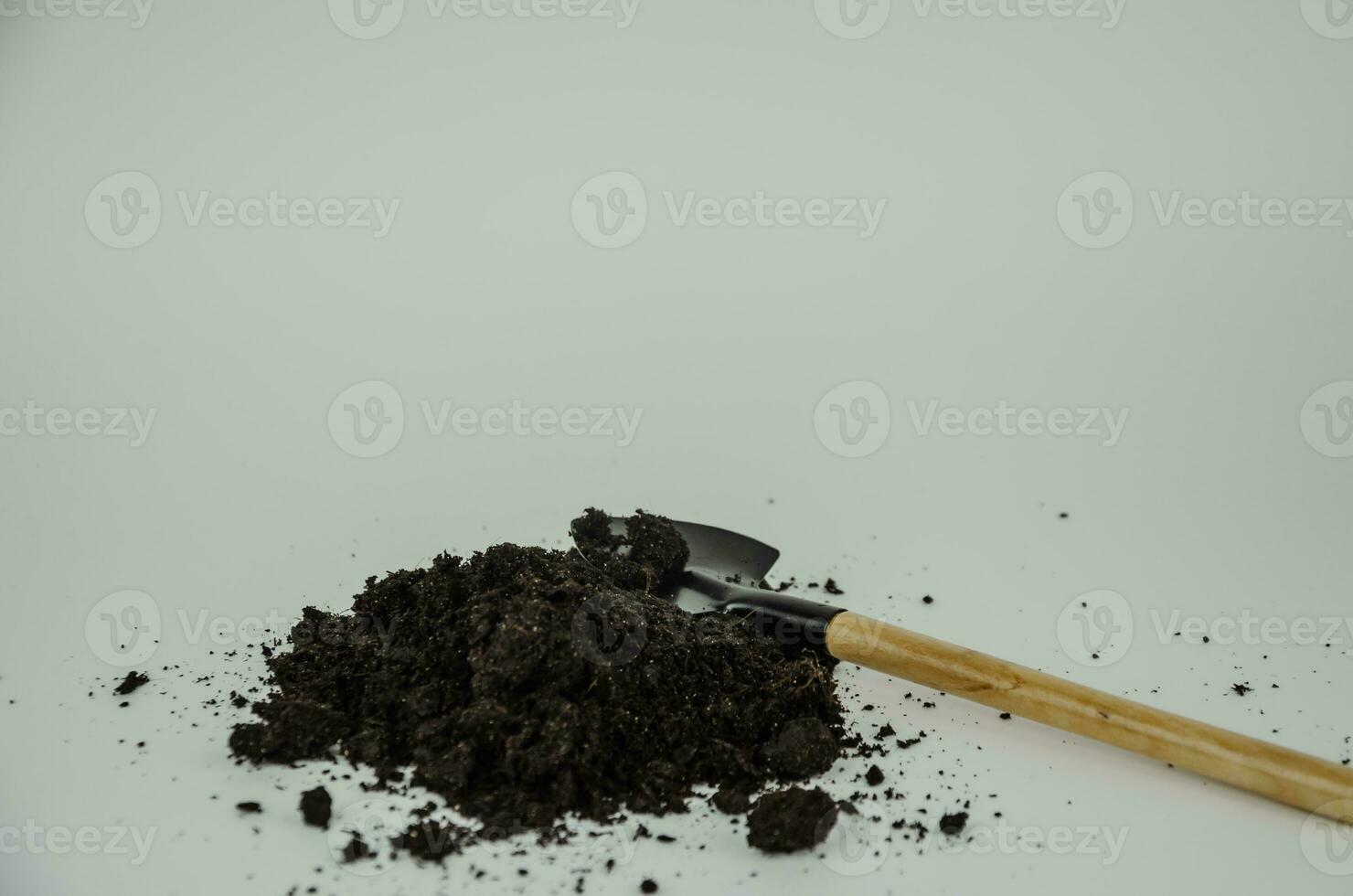 Ground with a shovel on a light background, planting concept photo