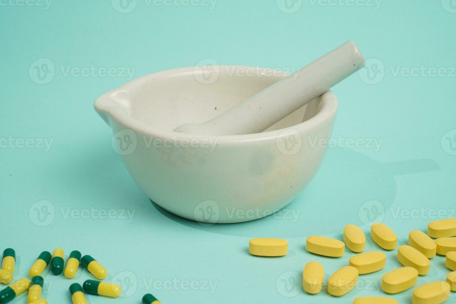 stamper mortar with tablets and capsules on the right and left photo
