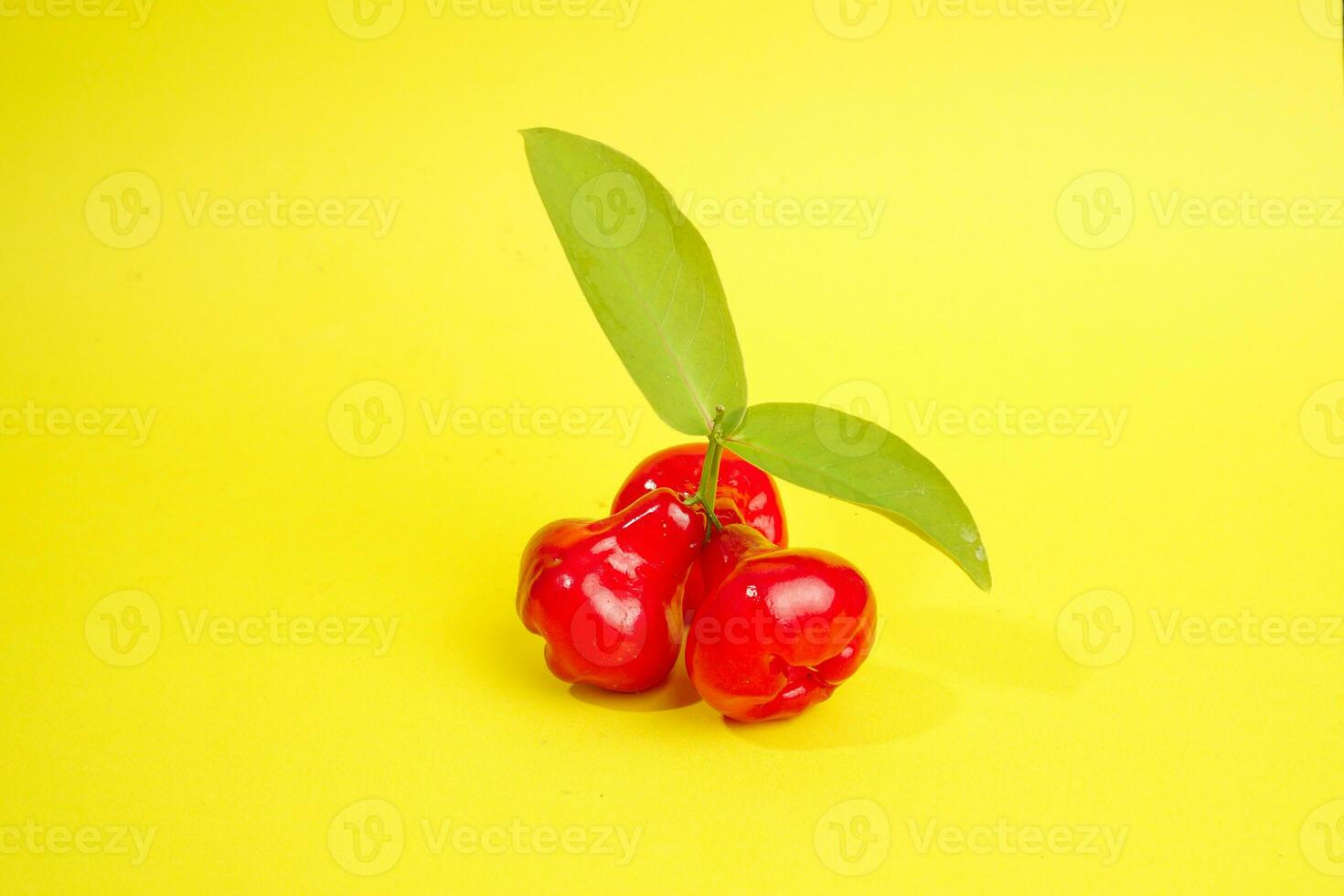 fresh water apple fruit and some water apple on basket behind on yellow background photo