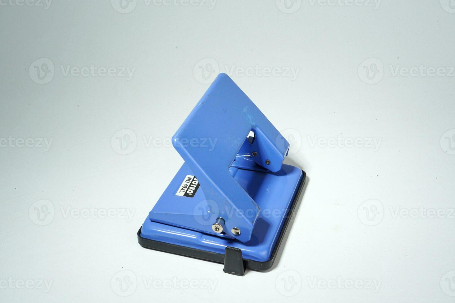 blue paper hole puncher on the white background photo