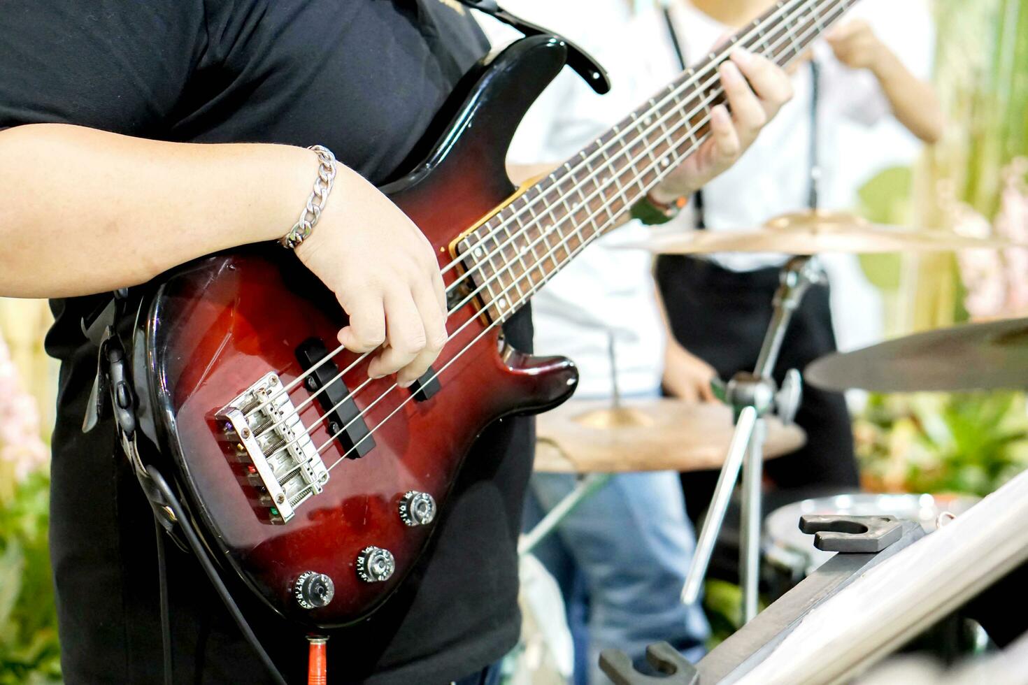 Closeup of musician's hands playing electric guitar on blurry background. photo