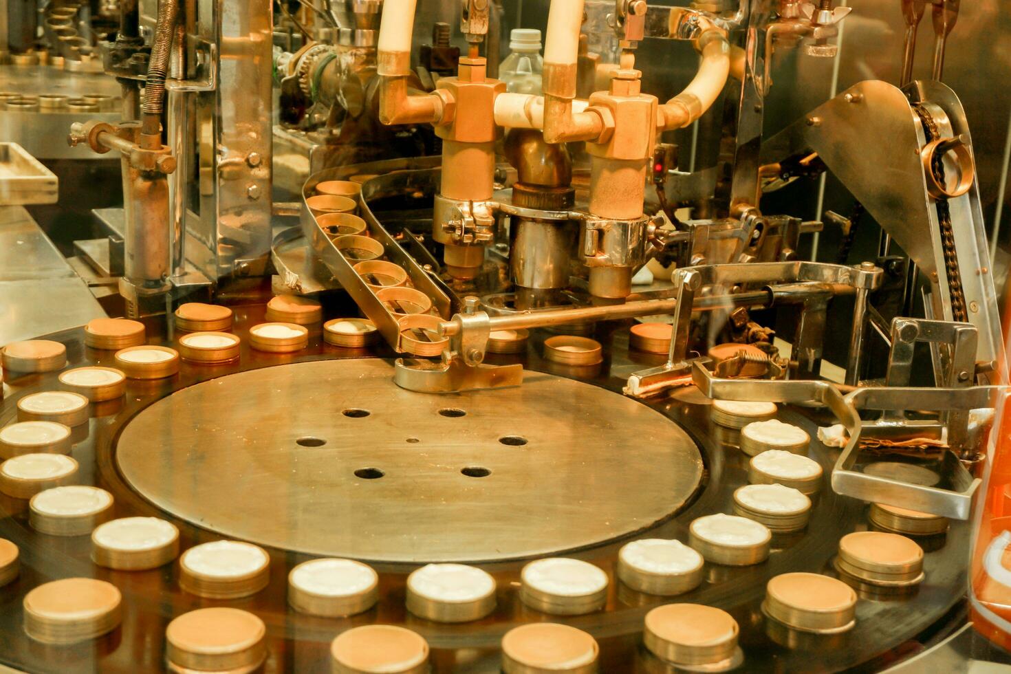 Cheese cake making machine in the bakery factory making and drop cheese cake ingredient in molds to prepare baked and sell to customer. photo
