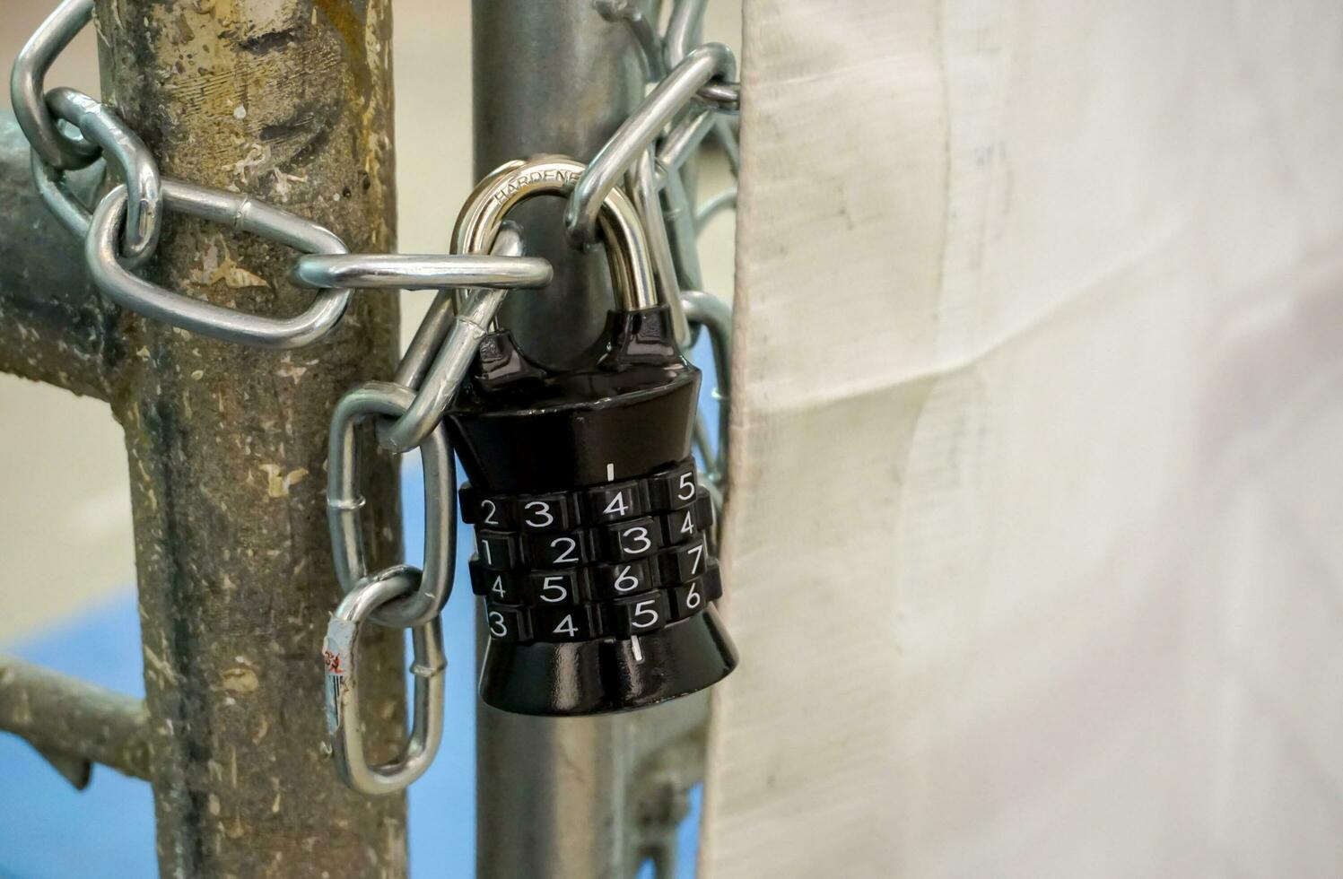 Closeup black combination lock with chain. photo