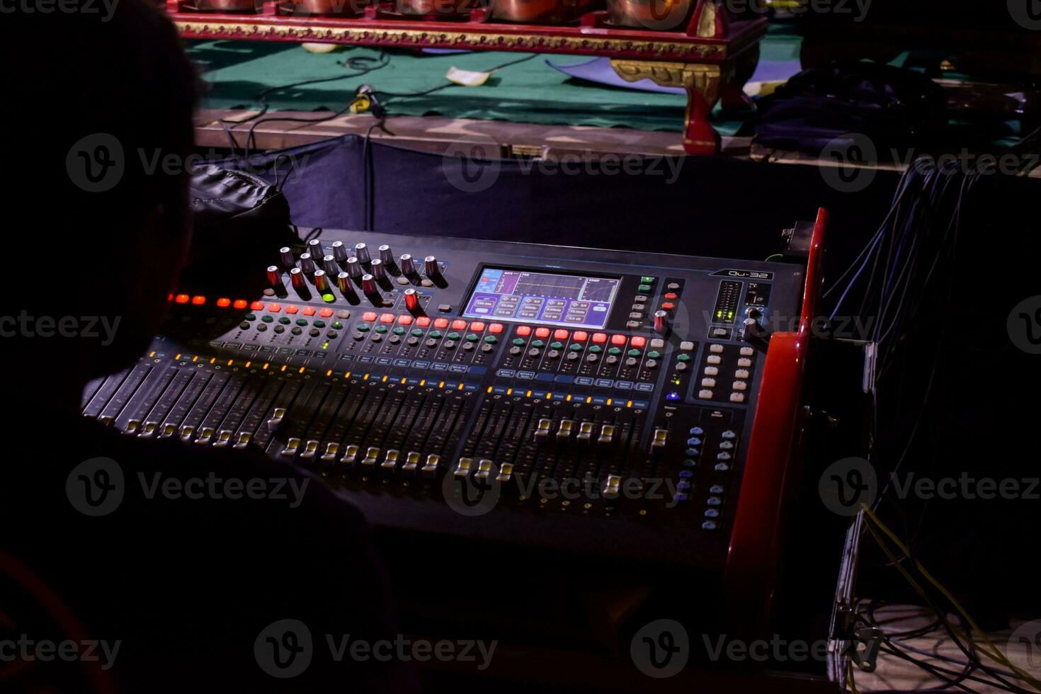 a man monitoring Sliders on the audio console. photo