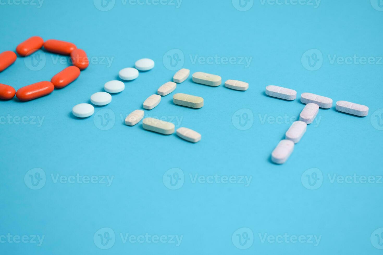 Diet word from Colorful Medicine Pills isolated on blue background, supplement, vitamin, colorful photo