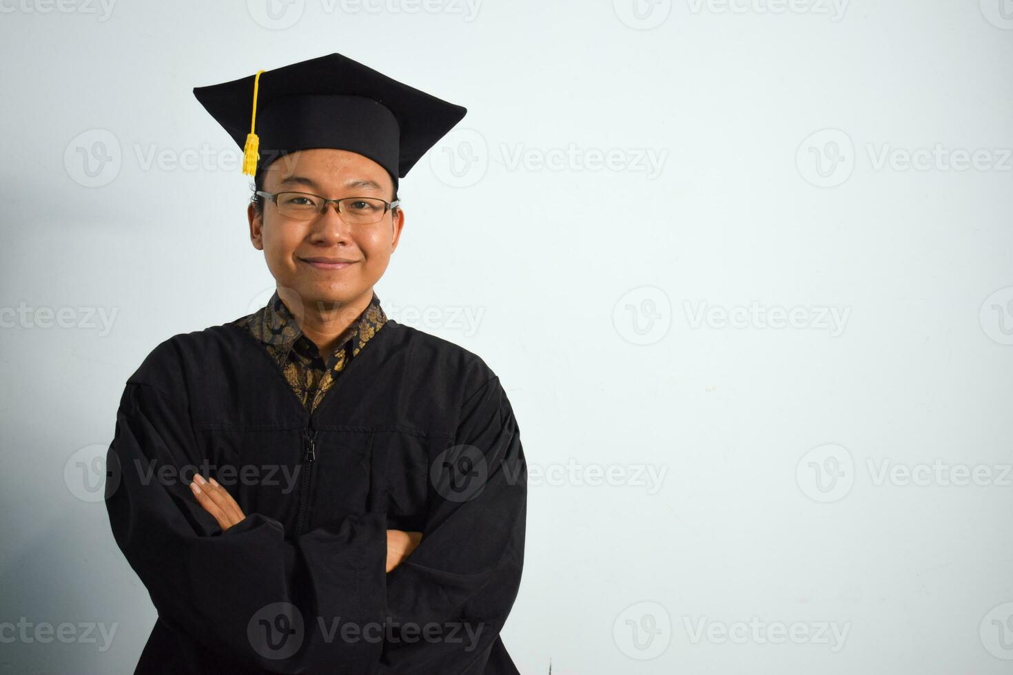 Expressive of Adult indonesia male wear graduation robe, hat and eyeglasses isolated on white background, expressions of portrait graduation photo