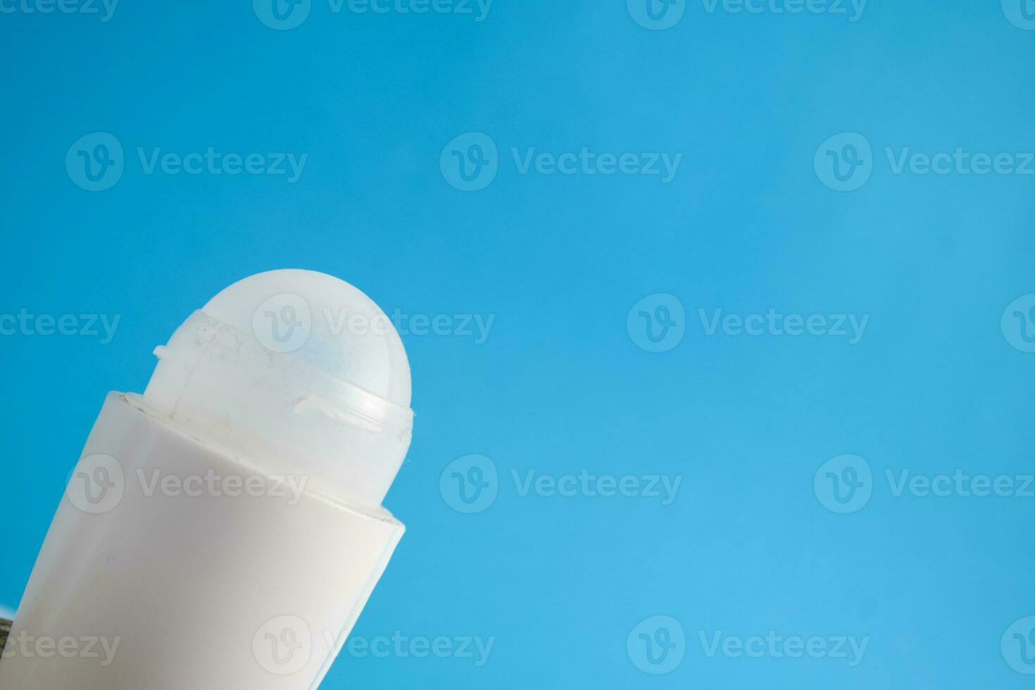White bottle deodorant blank for mock up on blue background, product mock up, armpit health care, body care photo