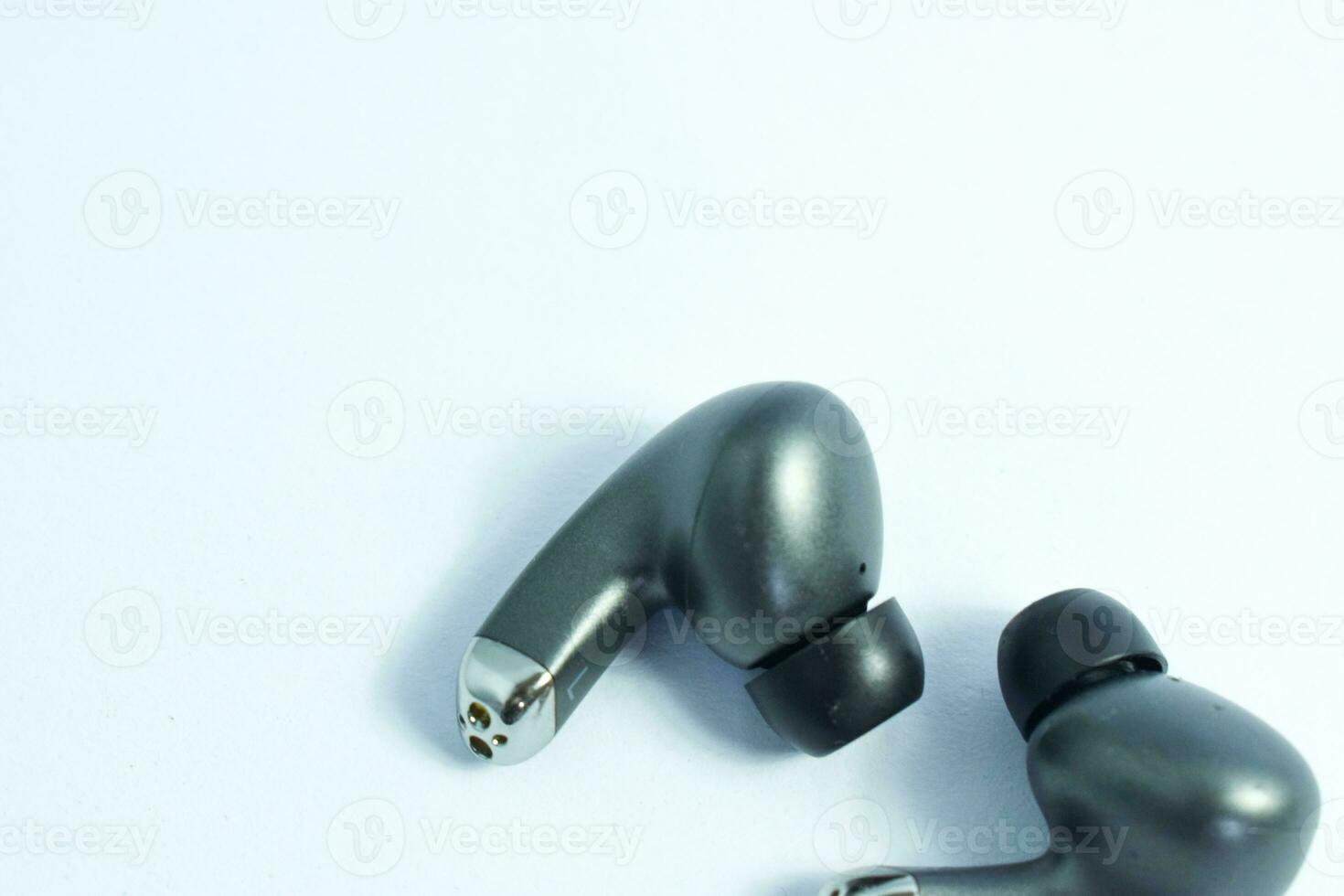 Silver wireless headset or earphone is called TWS, true wireless strereo for playing music without cable jack audio isolated on whote background photo