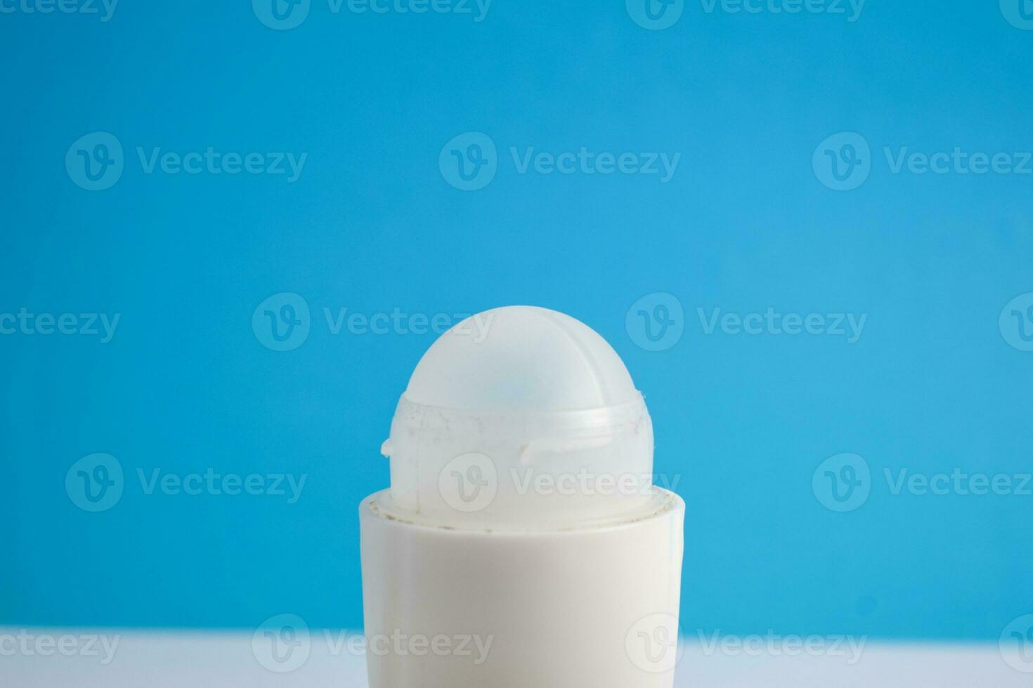 White bottle deodorant blank for mock up on blue background, product mock up, armpit health care, body care photo