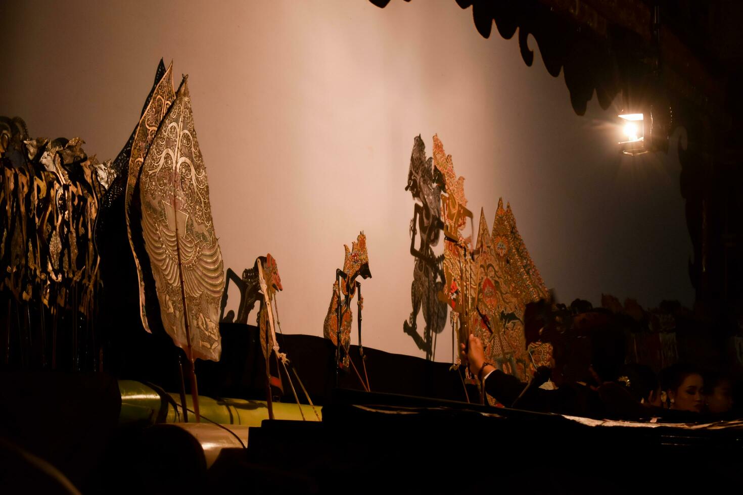 A man perform with wayang or traditional javanese puppet on stage at night. Tuban, Indonesia - 22 September, 2023. photo