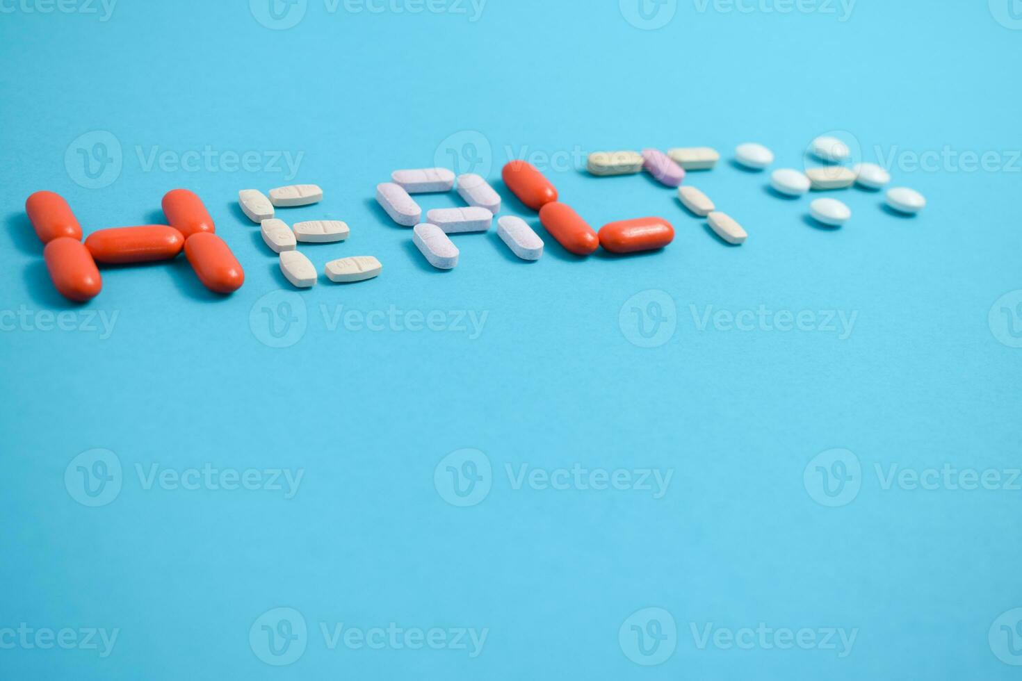 health word from Colorful Medicine Pills isolated on blue background, supplement, vitamin, colorful photo