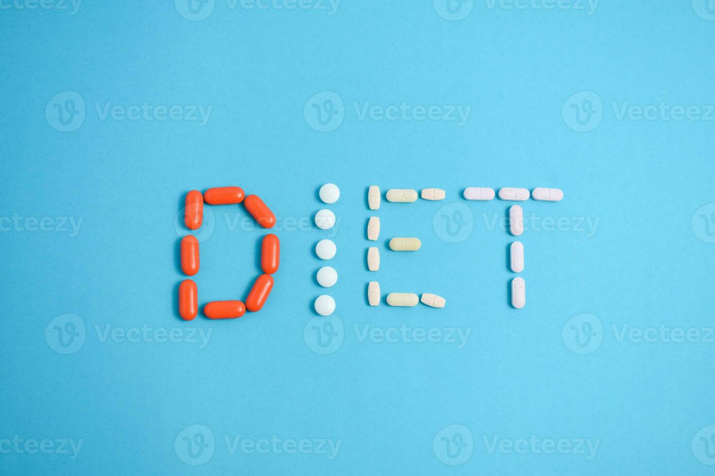 Diet word from Colorful Medicine Pills isolated on blue background, supplement, vitamin, colorful photo