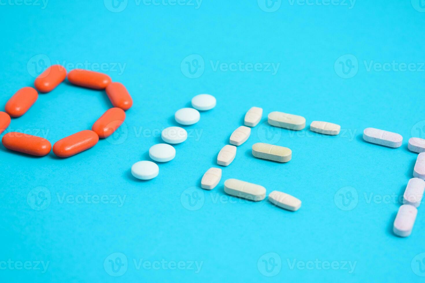 Diet word from Colorful Medicine Pills isolated on blue background, supplement, vitamin, colorful photo
