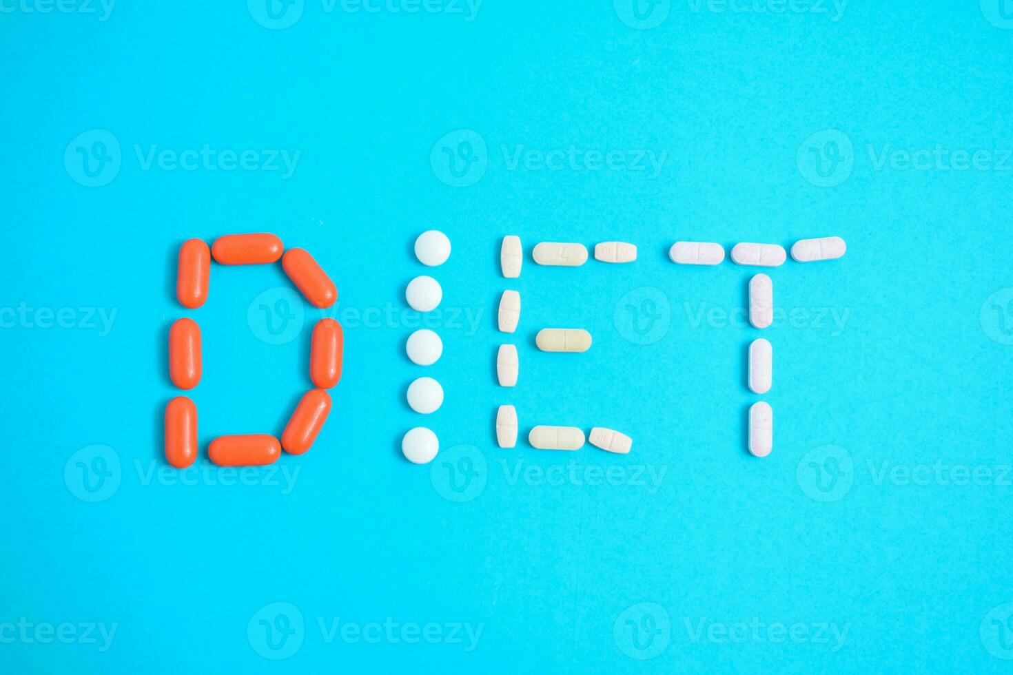 Diet word from Colorful Medicine Pills isolated on blue background, supplement, vitamin, colorful photo