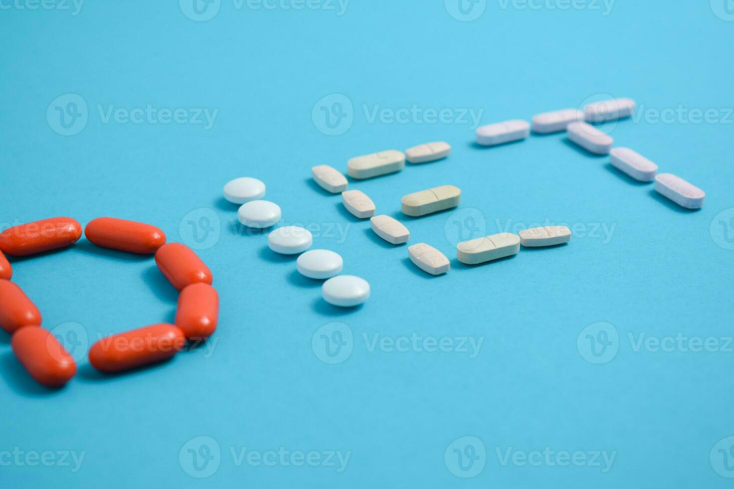Diet word from Colorful Medicine Pills isolated on blue background, supplement, vitamin, colorful photo