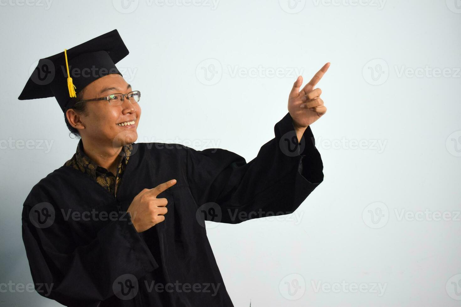 Expressive of Adult indonesia male wear graduation robe, hat and eyeglasses isolated on white background, expressions of portrait graduation photo