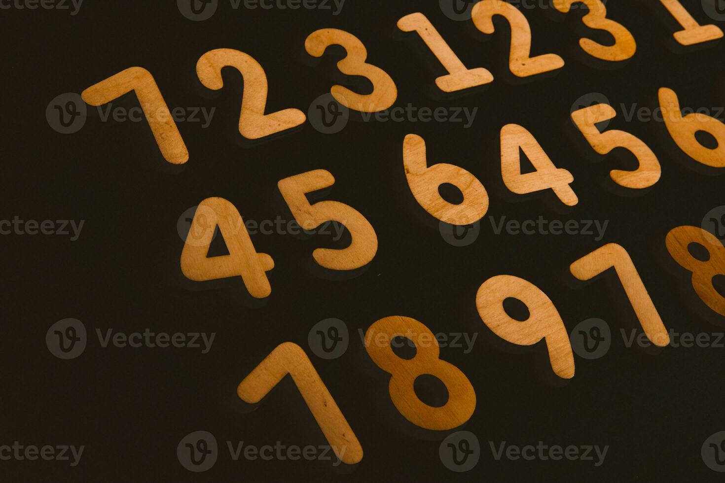 Colorful wooden numbers on a blackboard background with space for text photo