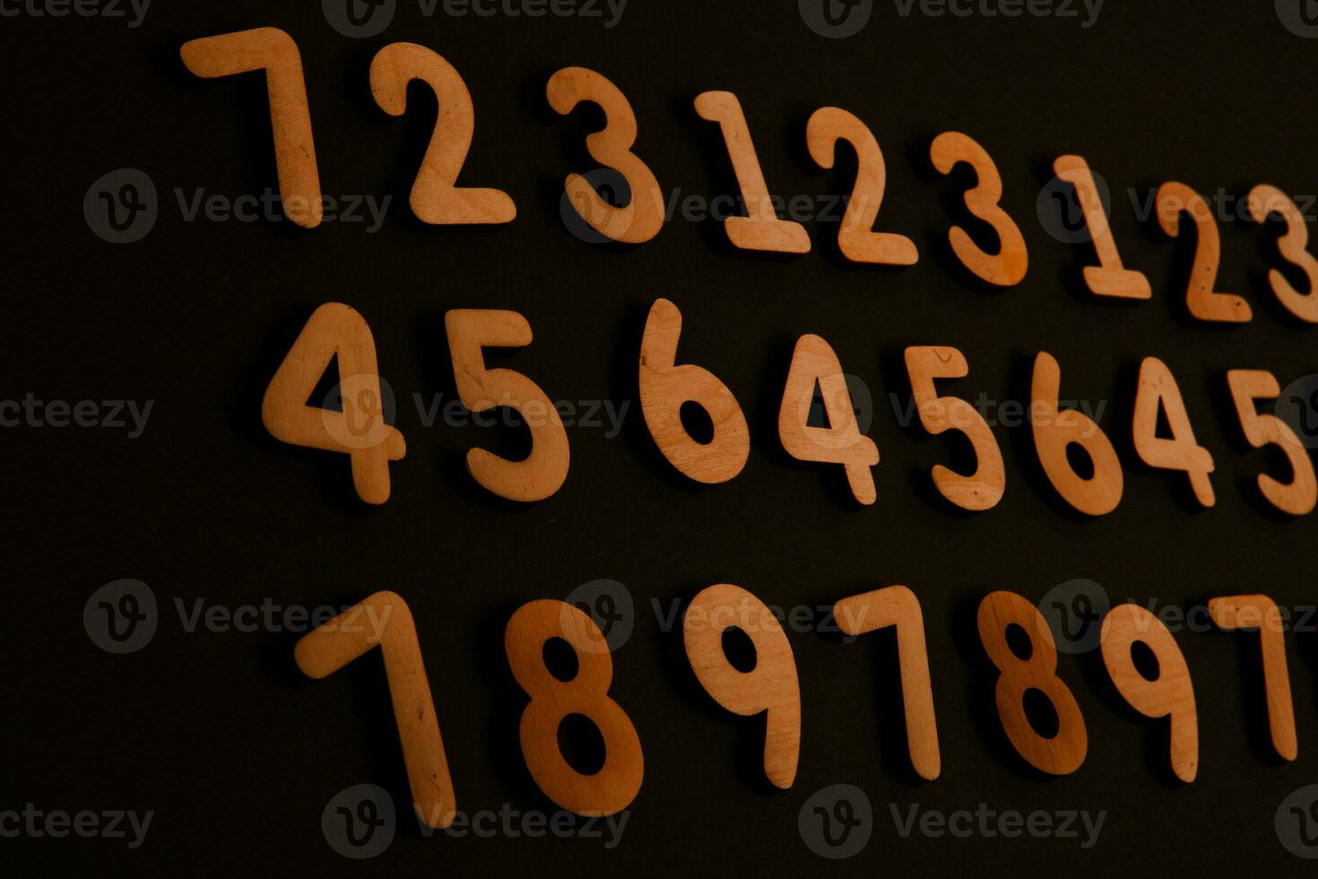 Wooden numbers on a black background. Numbers of different colors. photo